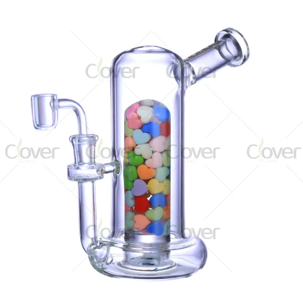 Glow in the dark glass oil rig with colorful heart decorations inside, made of durable borosilicate glass by Clover Glass