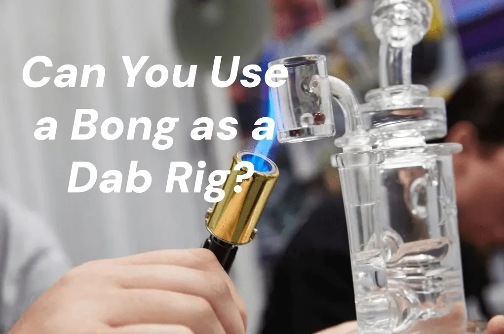 Hand using a torch to heat a glass banger on a clear dab rig.