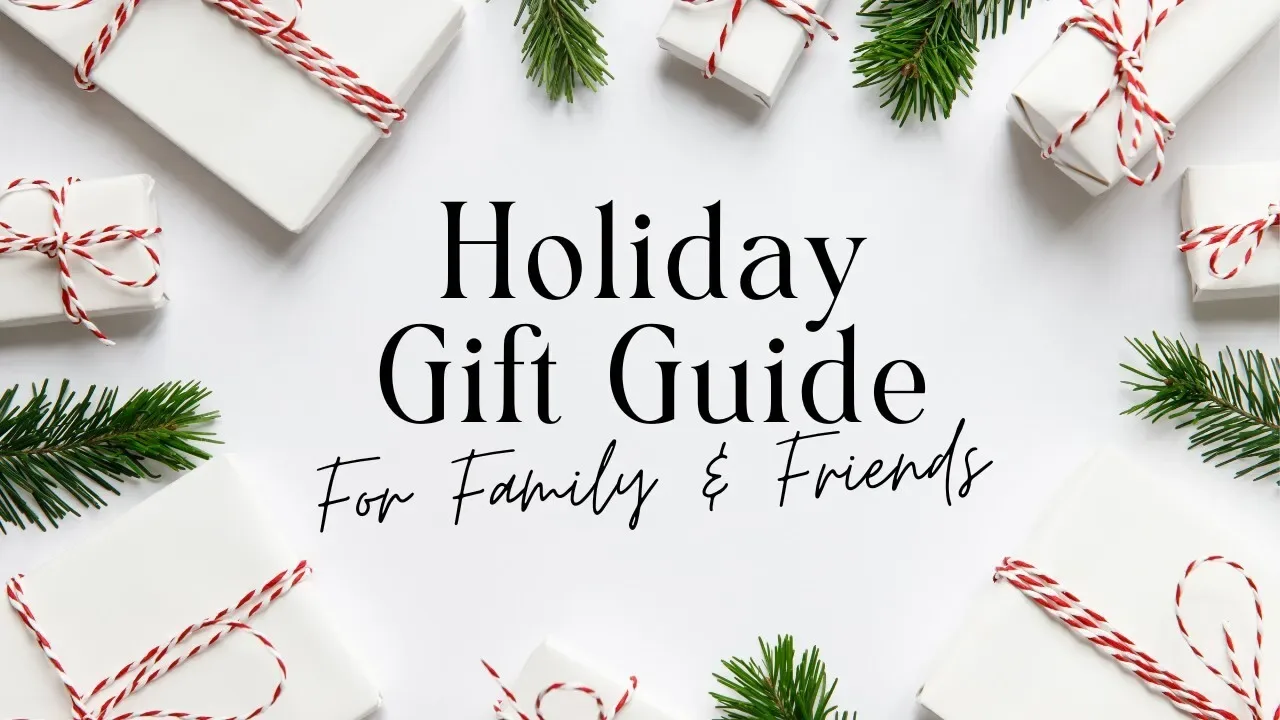 Festive holiday gift guide image with white presents and evergreen accents.