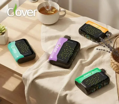 Four colorful Cover disposable vapes with constellation designs arranged on a wooden table.