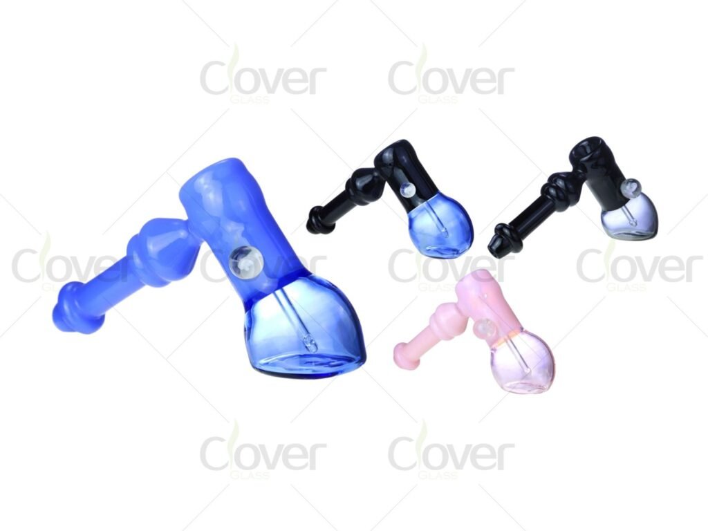 Assorted colored glass hammer bubbler pipes, blue, black, and pink, smoking accessories.