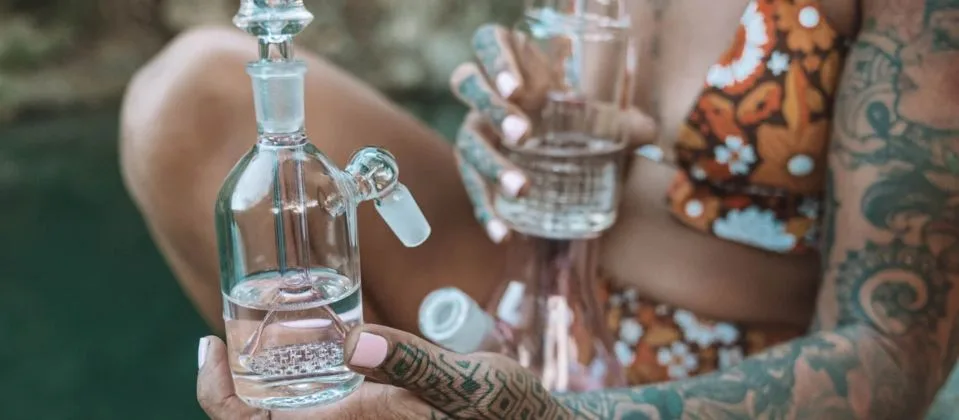 clear glass ash catcher attached to bong