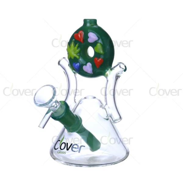 Green donut glass bong with colorful hearts and cannabis leaf design.
