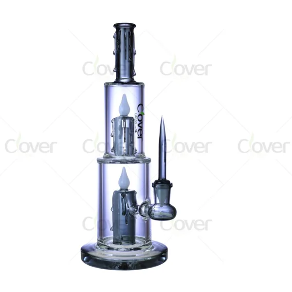 Clear glass dab rig with dual candle percolators, melting wax top, and dab tool.