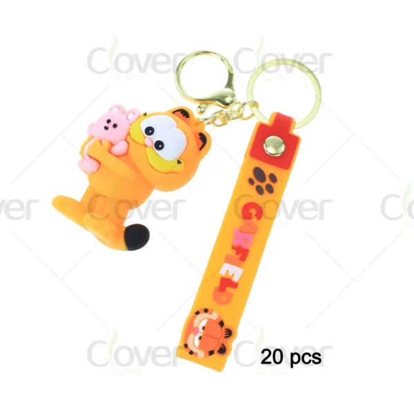 Garfield holding pink teddy bear silicone keychain with yellow strap and metal keyring.