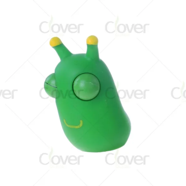 Green slug-like toy with pop-out eyes, yellow antennae, and smiling mouth.