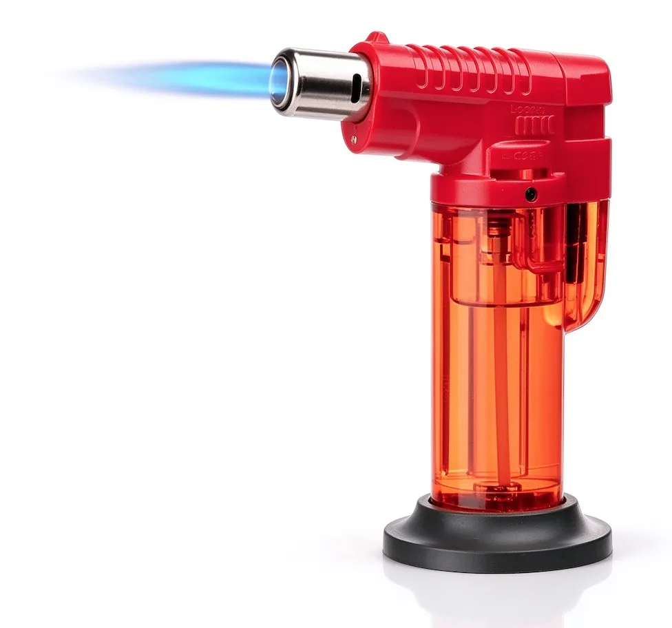 Red butane torch lighter with a powerful blue flame on white.