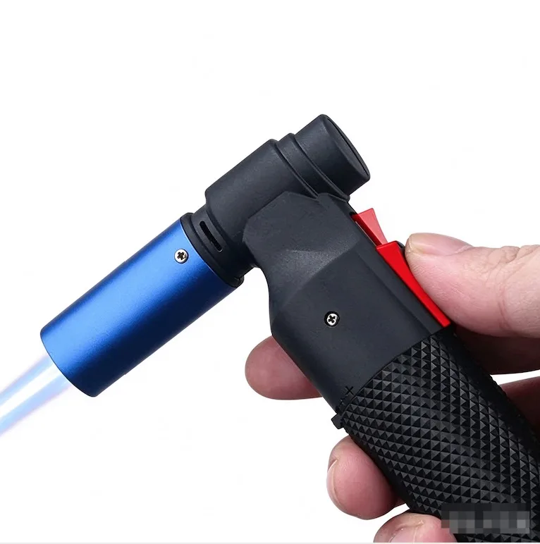 Hand holding a blue and black butane torch lighter emitting a powerful blue flame.